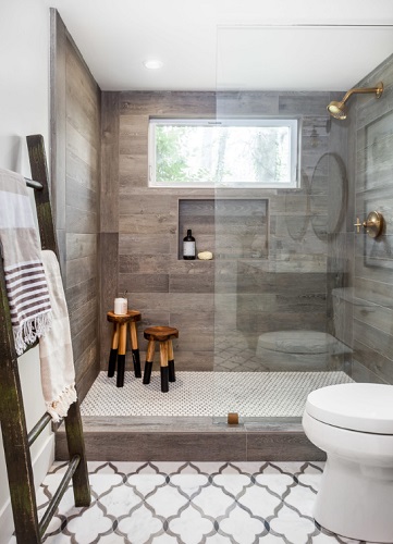 Luxury Farmhouse Bathroom by Juxtaposed Interiors