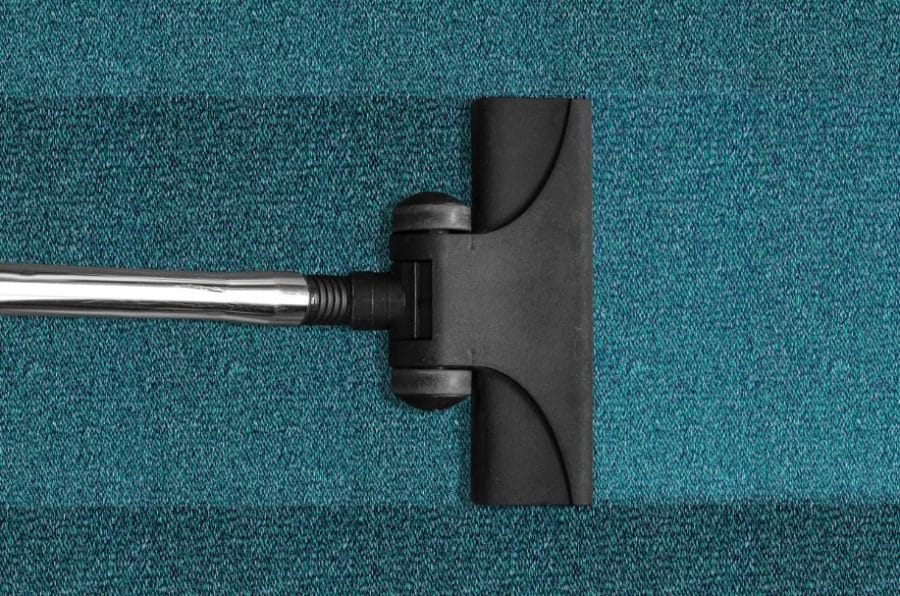 Vacuum Cleaner Getting Dirt And Debris Off A Rug Scaled